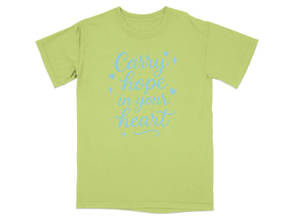 Light green t-shirt with "Carry hope in your heart" text in blue script.