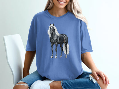 Black horse with flowing white mane and tail on blue t-shirt.