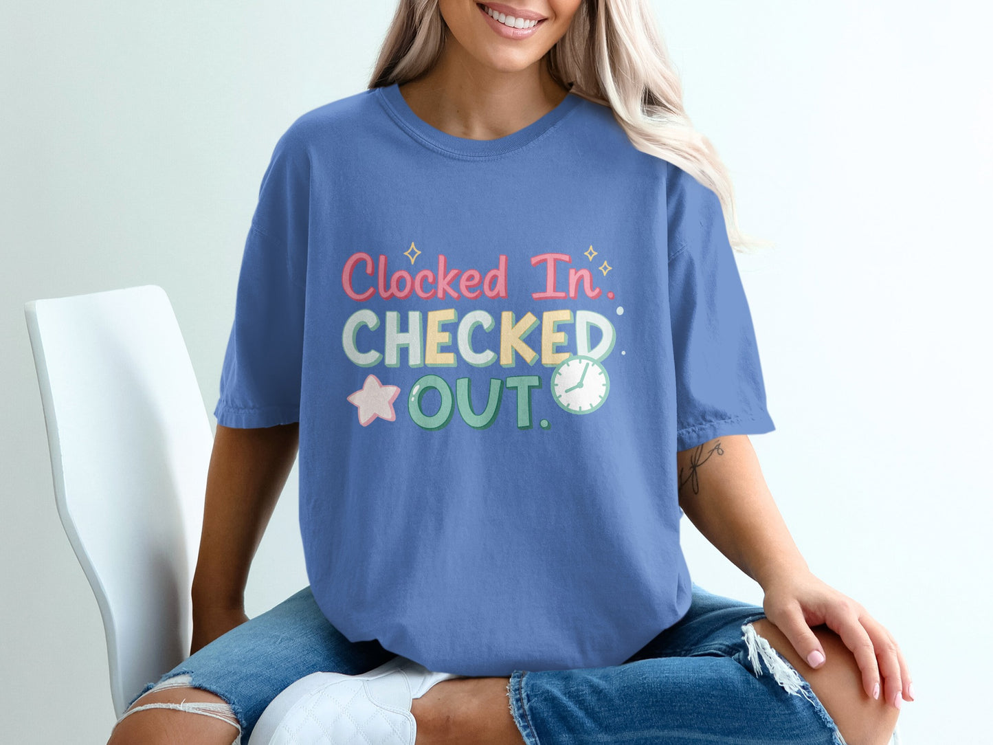 Blue t-shirt with "Clocked In, Checked Out" text and star graphic.