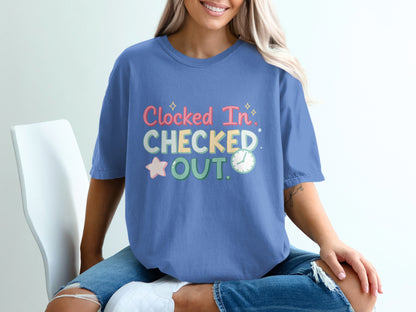 Blue t-shirt with "Clocked In, Checked Out" text and star graphic.
