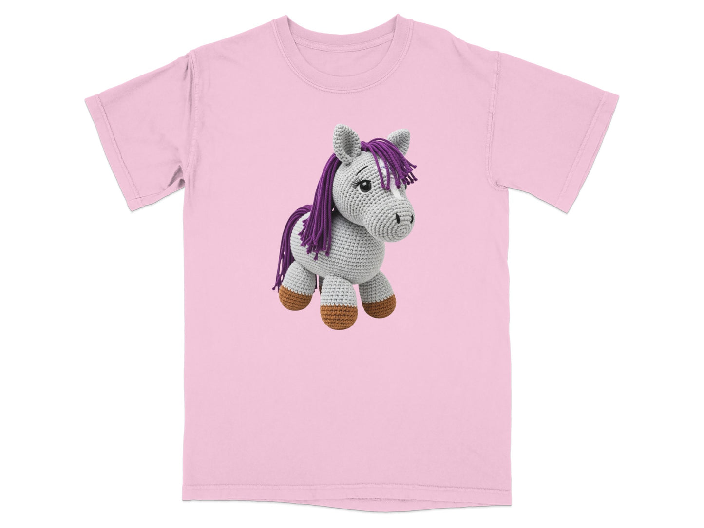 Pink t-shirt with a grey crocheted horse plush toy.