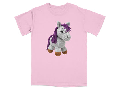 Pink t-shirt with a grey crocheted horse plush toy.