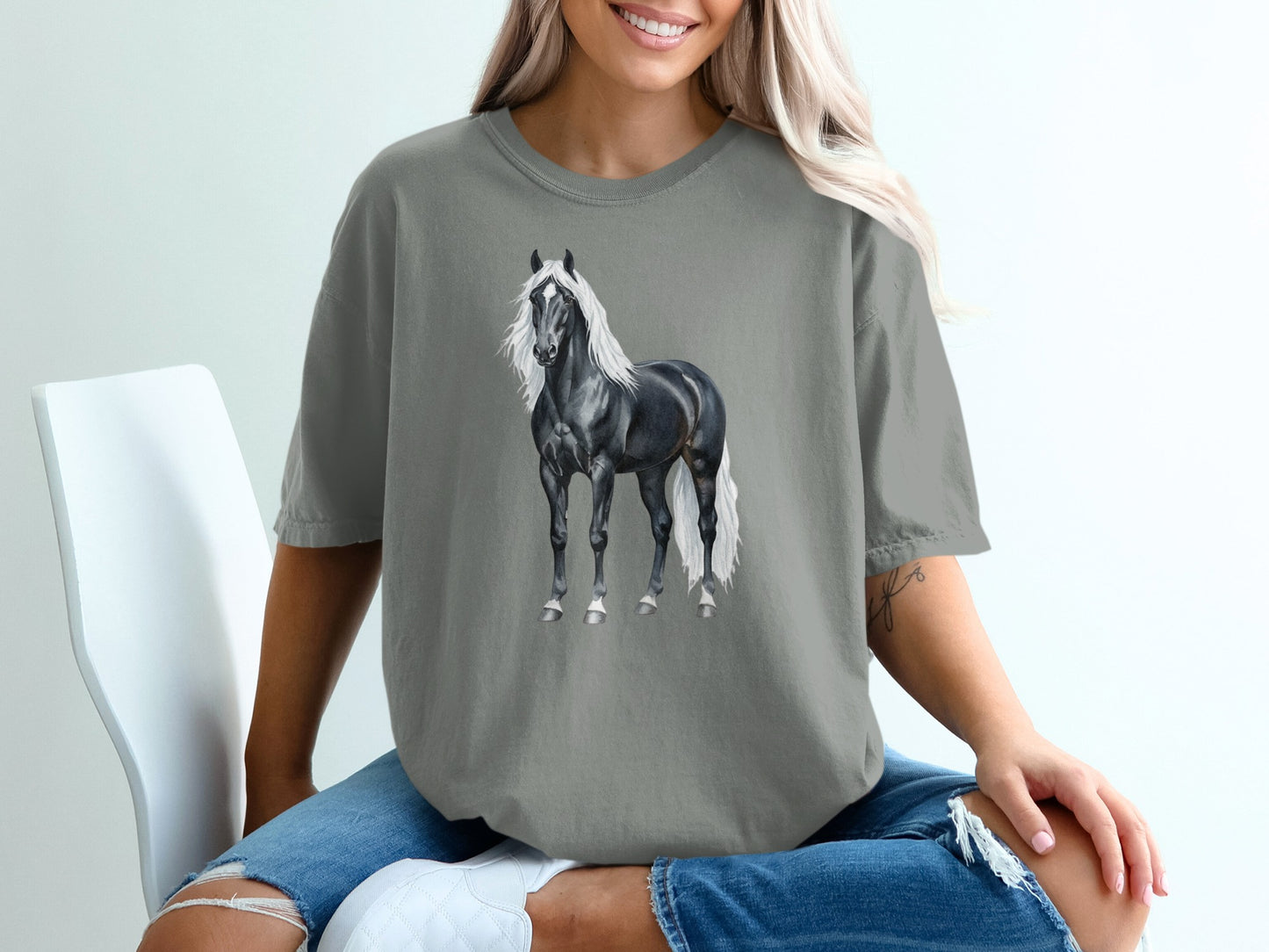 Black horse with white mane and tail on grey t-shirt.