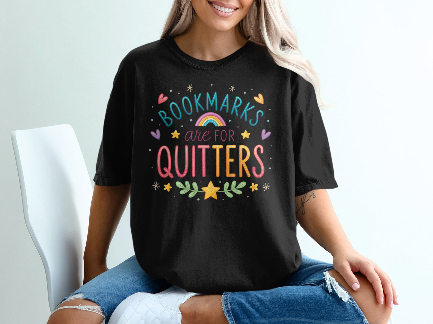 Black t-shirt with colorful "Bookmarks are for quitters" text and graphic.
