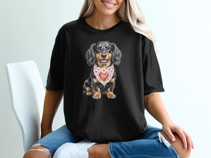Black t-shirt featuring a long-haired dachshund wearing a heart-patterned bandana.