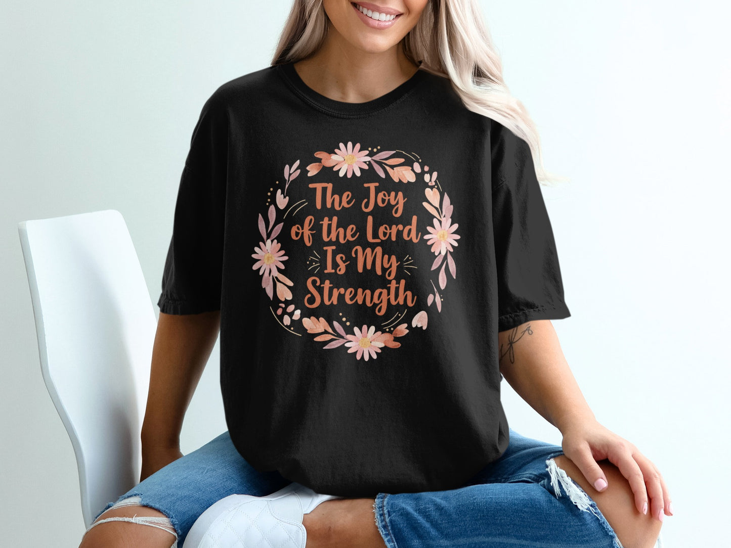 Black t-shirt with "The Joy of the Lord Is My Strength" floral wreath design.