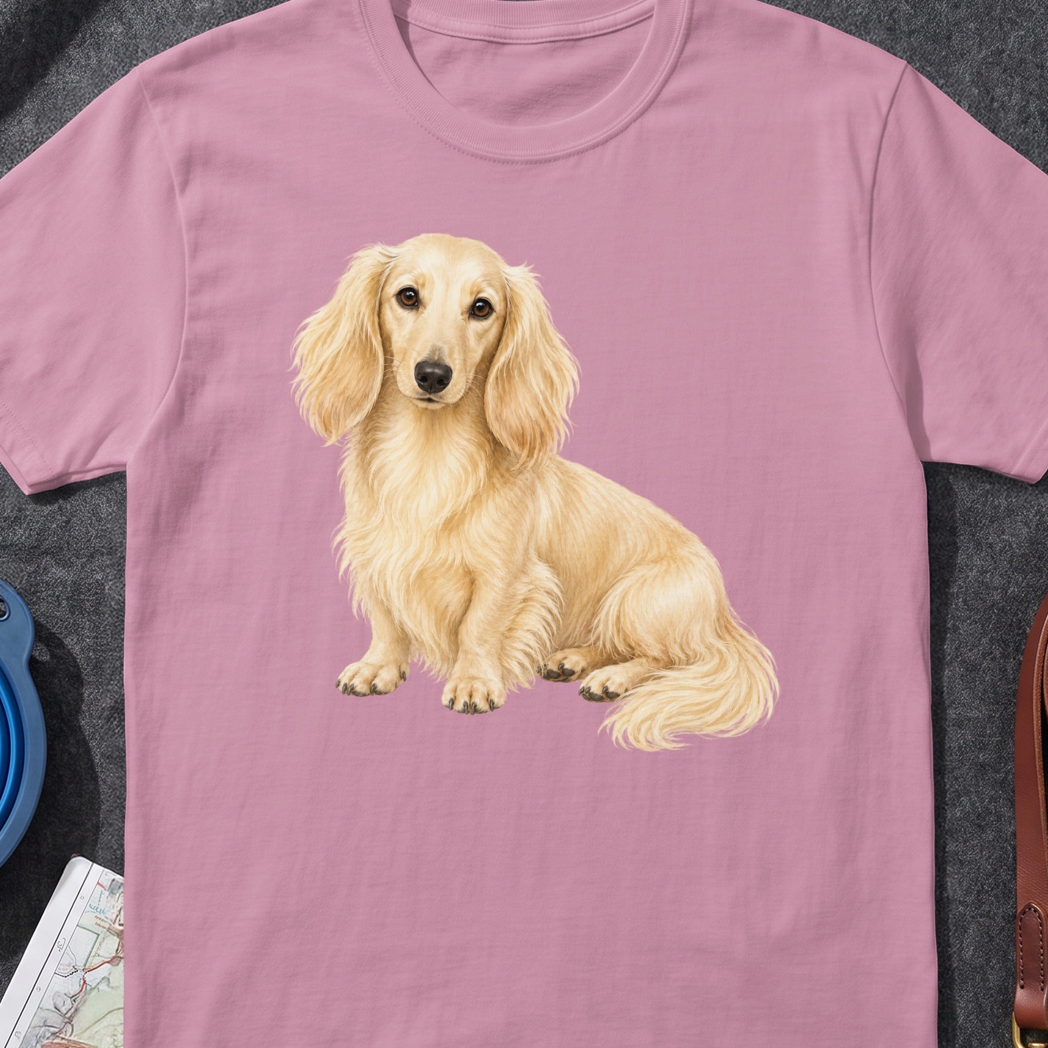 Long-haired cream dachshund illustration on a pink t-shirt.