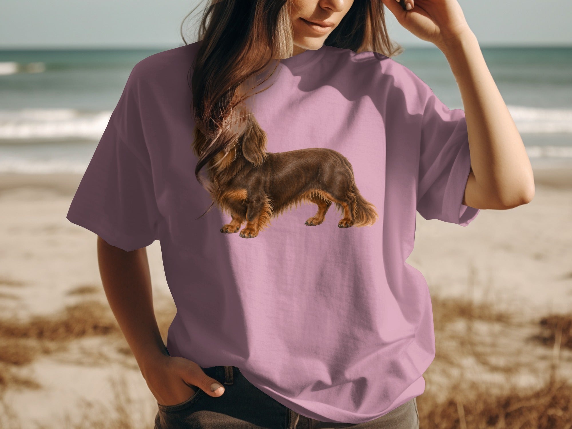 Pink t-shirt with a long-haired brown dachshund illustration on the front.