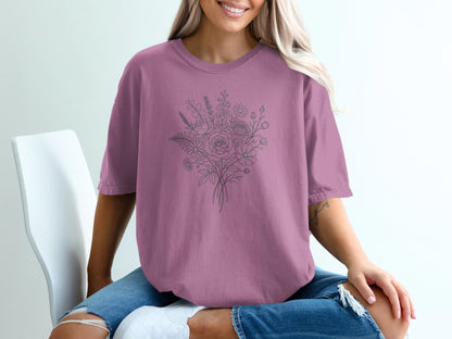 Mauve t-shirt with a delicate line drawing of a floral bouquet.