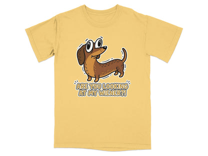 Yellow t-shirt with a cartoon dachshund asking "ARE YOU LOOKING AT MY WIENER?!".