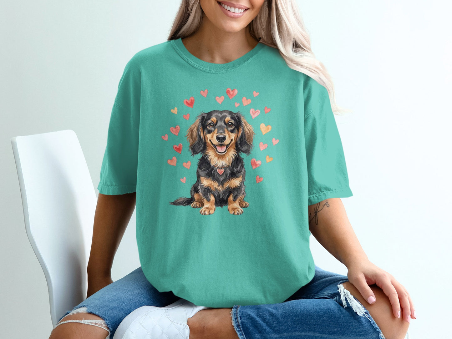 Teal t-shirt with watercolor dachshund and hearts design.