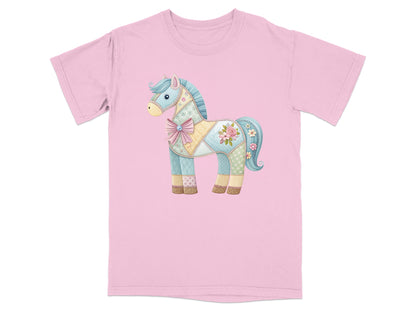 Pink t-shirt with a patchwork horse graphic featuring floral patterns and a bow.