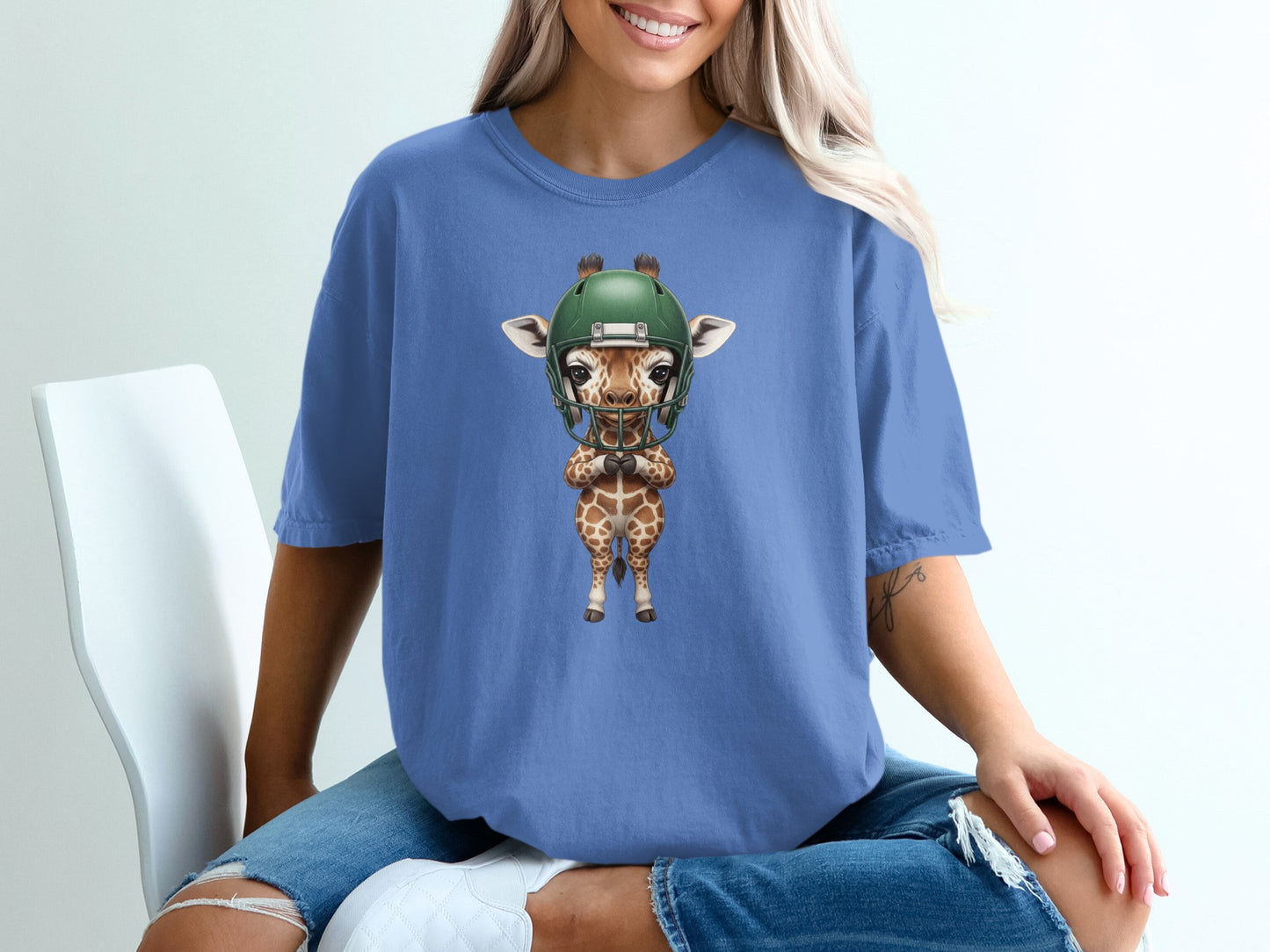 Giraffe wearing a green football helmet and shoulder pads.