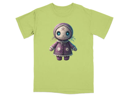 Purple doll with star eyes on a light green t-shirt.
