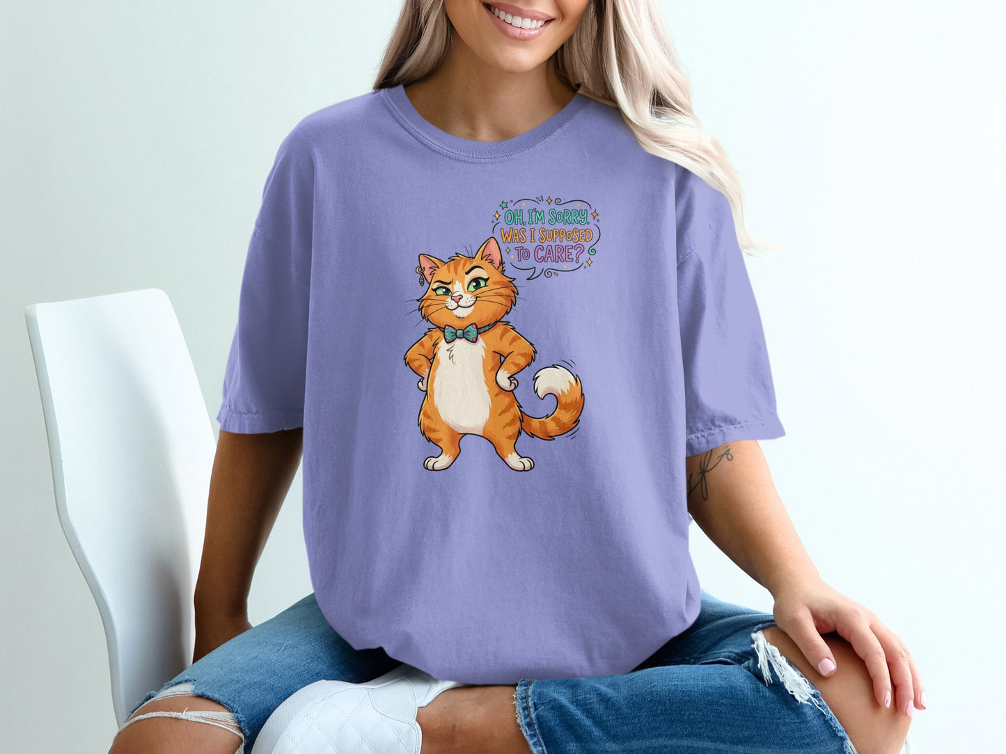 Purple t-shirt with an illustrated cat asking, "Oh, I'm sorry, was I supposed to care?"