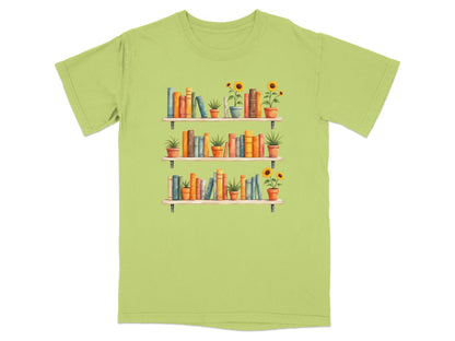 Three shelves of books and potted sunflowers on a light green t-shirt.