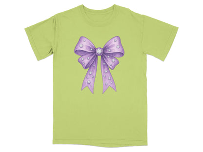 Green t-shirt with a purple sequined bow graphic.