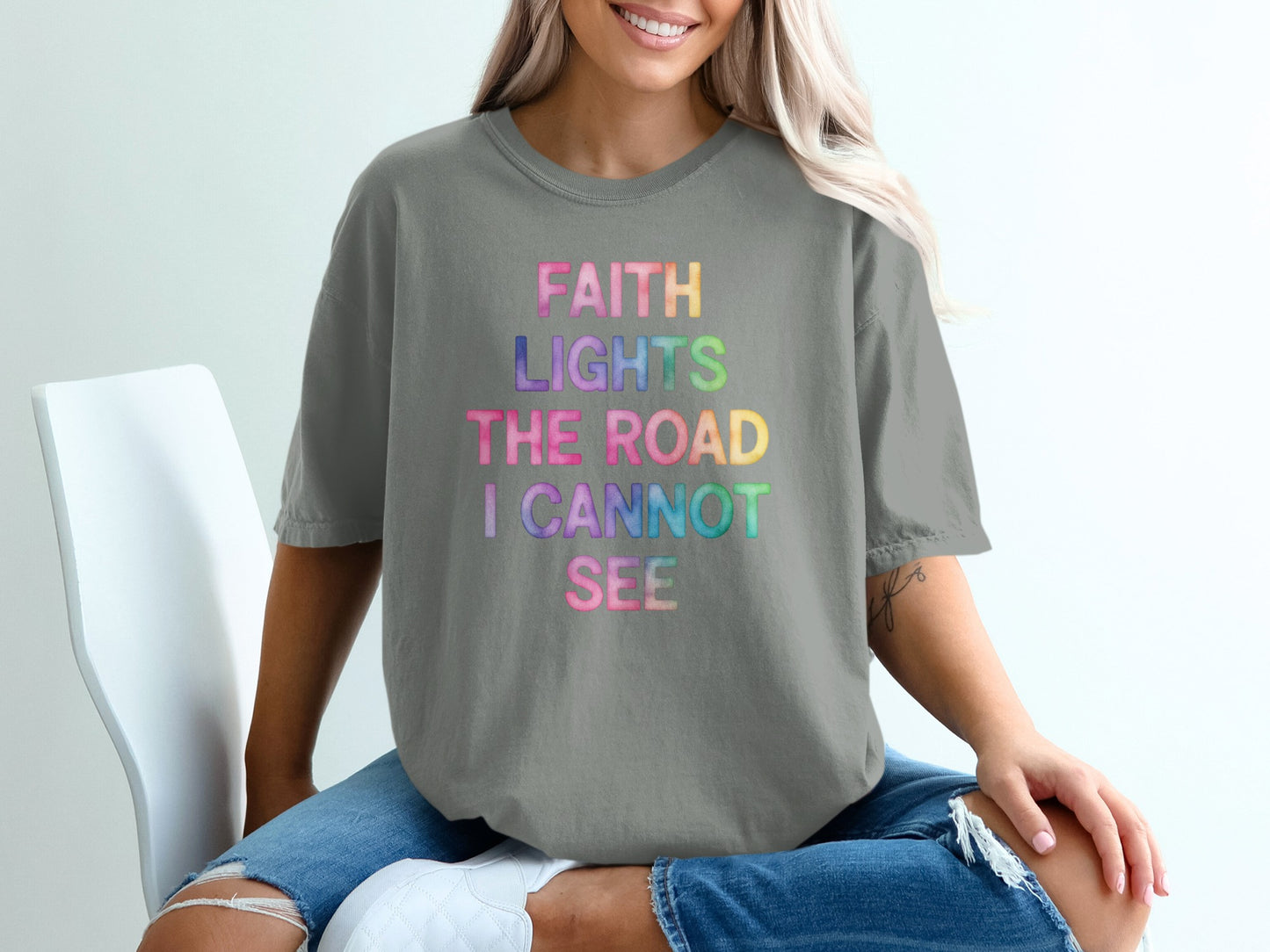 Grey t-shirt with "FAITH LIGHTS THE ROAD I CANNOT SEE" in colorful text.