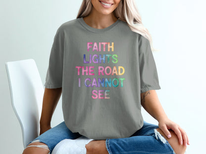 Grey t-shirt with "FAITH LIGHTS THE ROAD I CANNOT SEE" in colorful text.