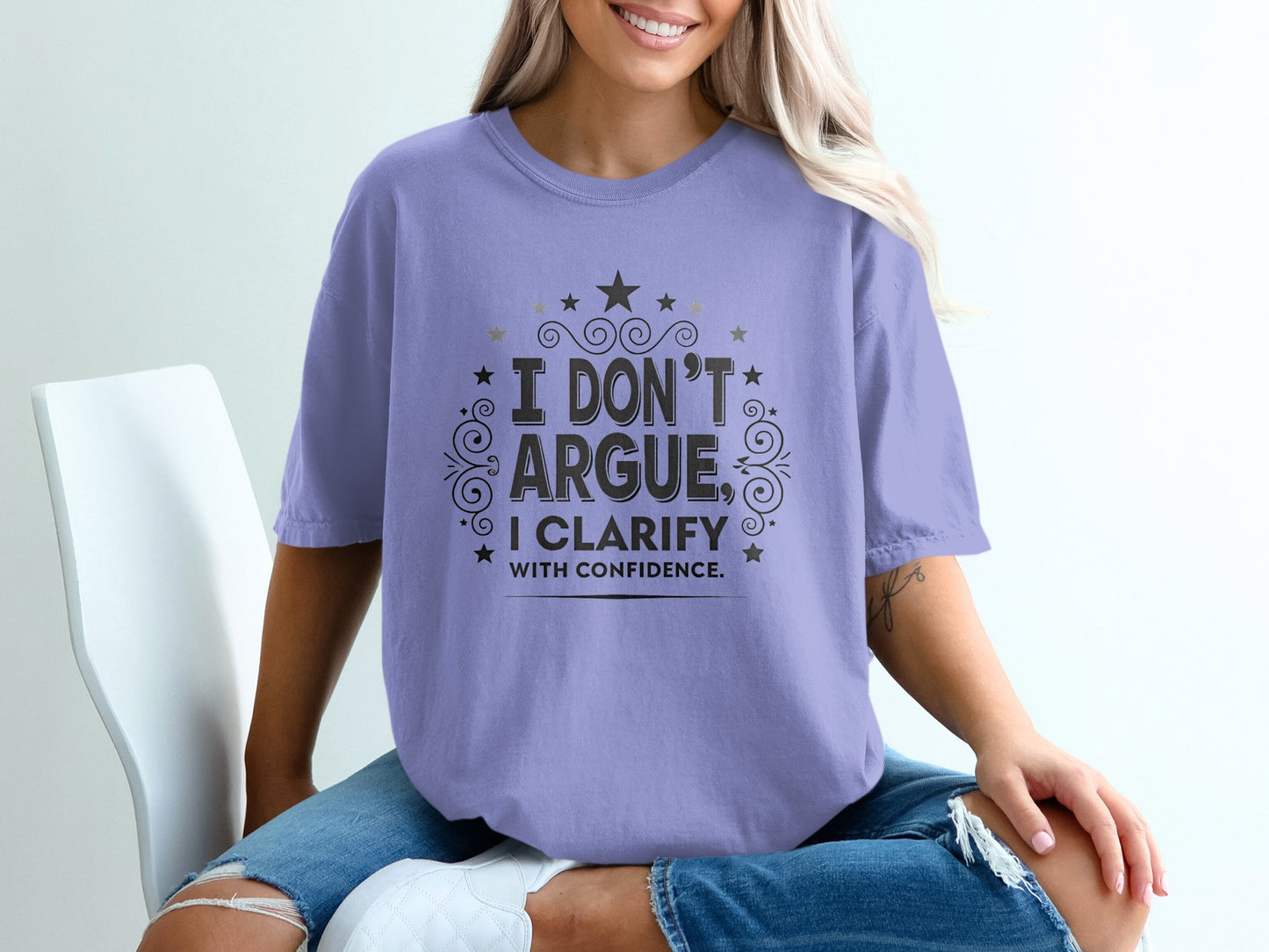 Purple t-shirt with "I DON'T ARGUE, I CLARIFY WITH CONFIDENCE" text.