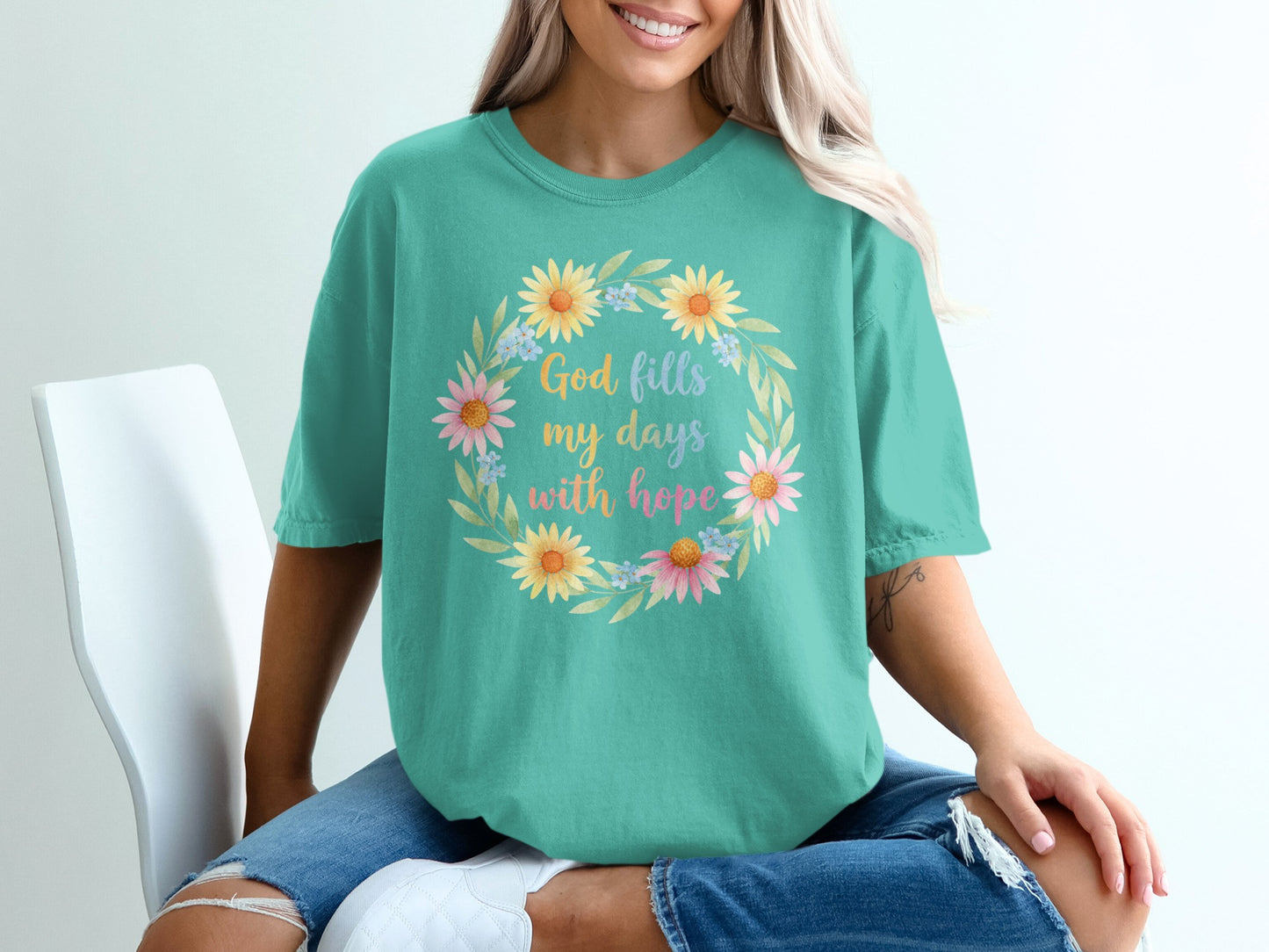 Teal t-shirt with floral wreath and text "God fills my days with hope".