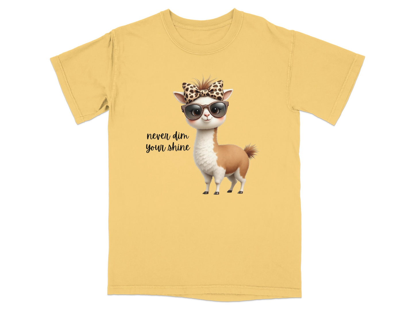 Yellow t-shirt with a llama wearing sunglasses and a bow, text "never dim your shine."