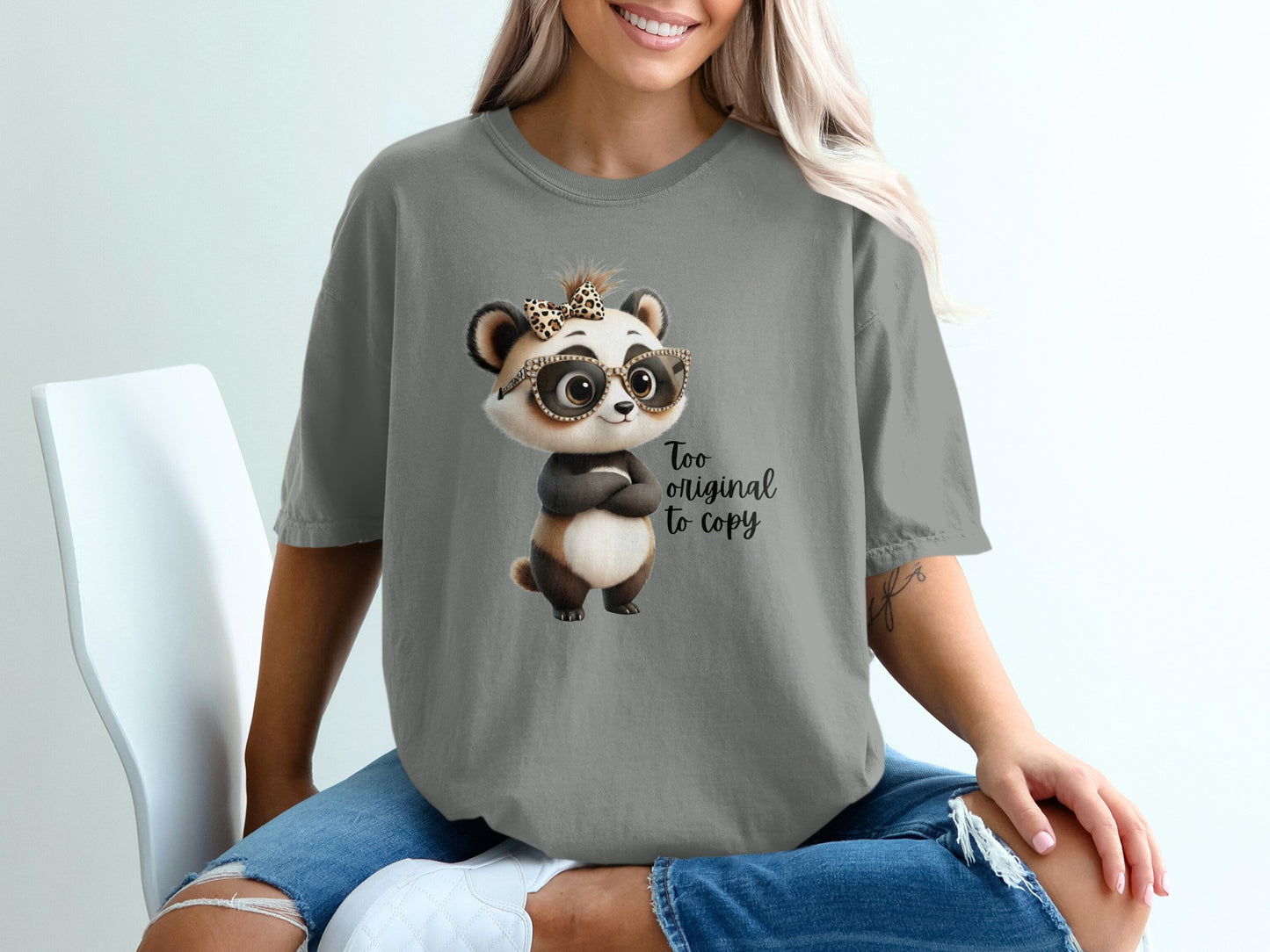 Grey t-shirt with cartoon panda wearing glasses and leopard print bow, "Too original to copy" text.