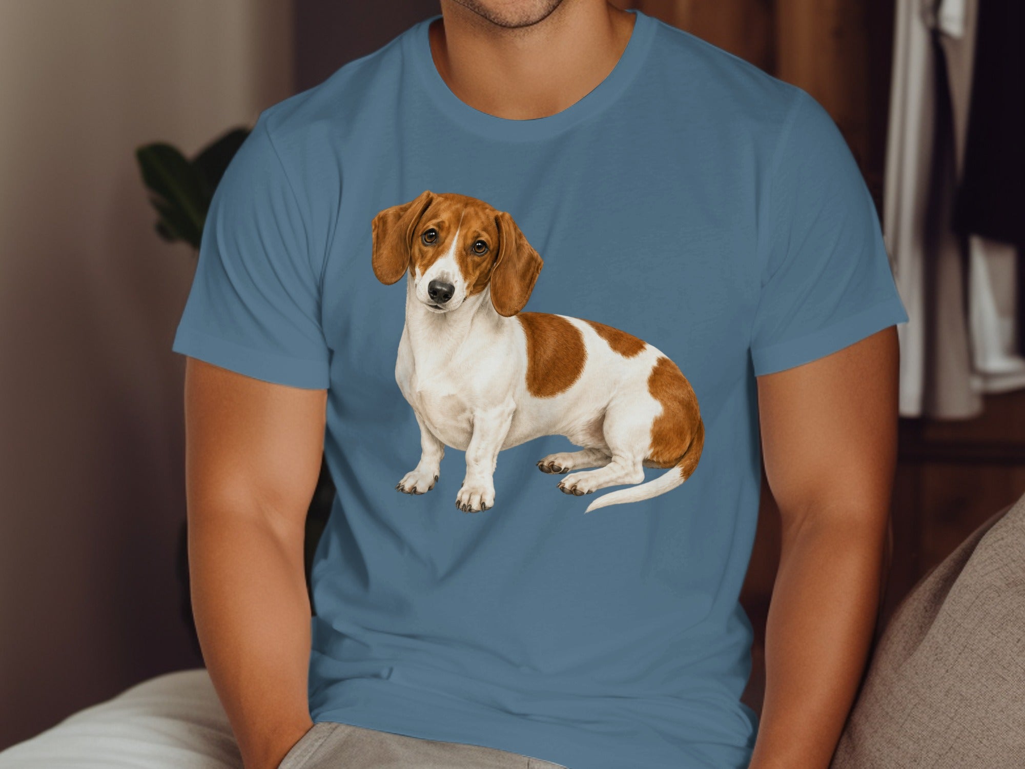 Dachshund dog graphic on a blue t-shirt worn by a person.