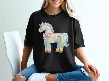 Black t-shirt with a quilted, pastel horse graphic featuring floral accents.
