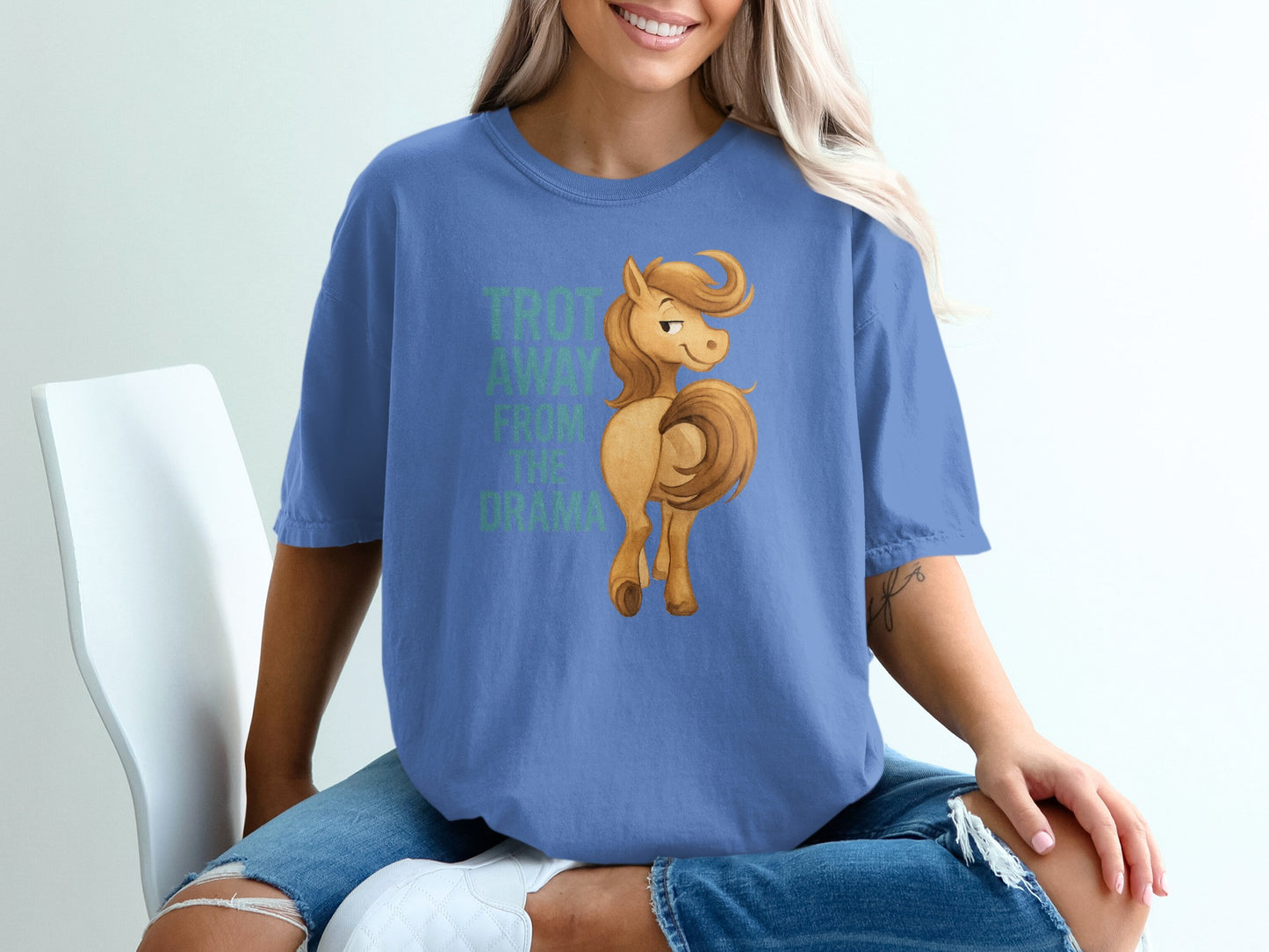Blue t-shirt with cartoon horse and text " Trot away from the drama".