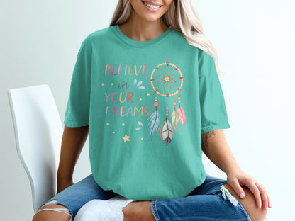 Teal t-shirt with "Believe in your dreams" and dreamcatcher graphic.