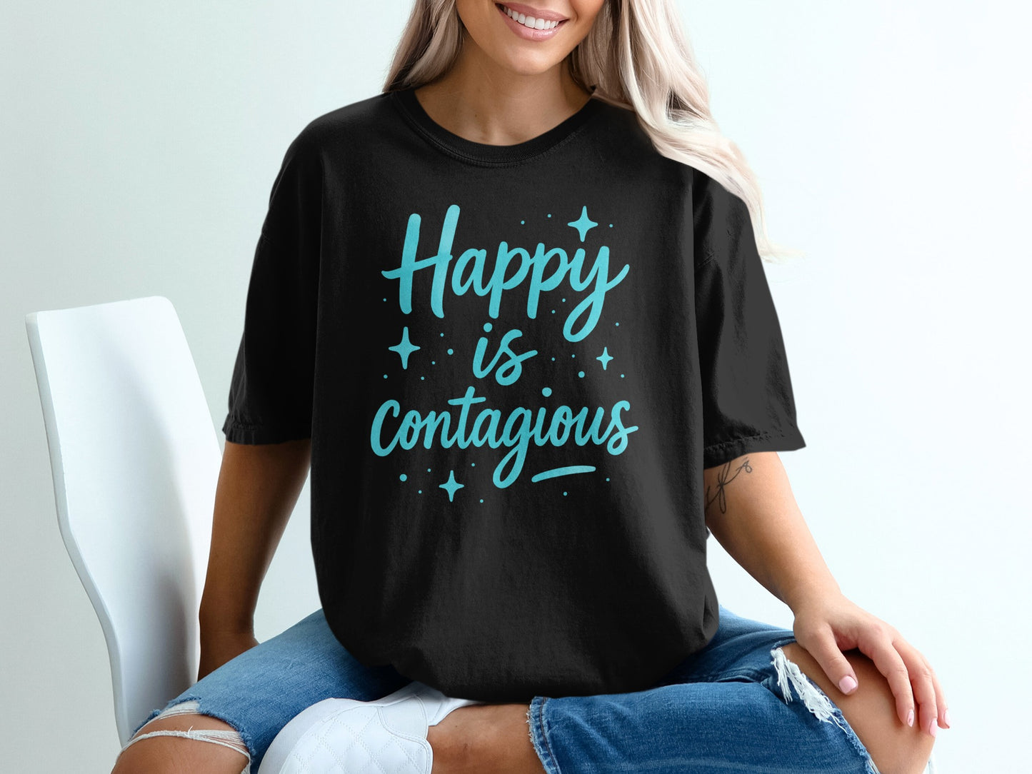 Black t-shirt with "Happy is Contagious" text and stars.