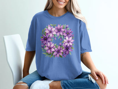 Periwinkle t-shirt with a floral wreath design of purple lilies.