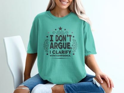 Teal t-shirt with "I don't argue, I clarify with confidence" text.