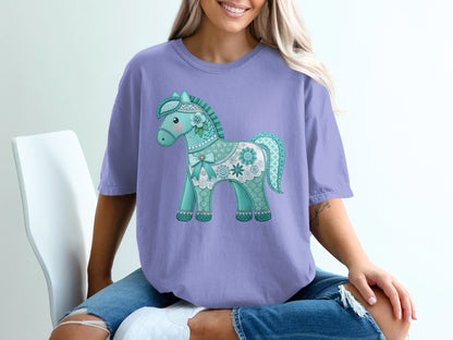 Teal and white floral-patterned horse graphic on a lavender t-shirt.