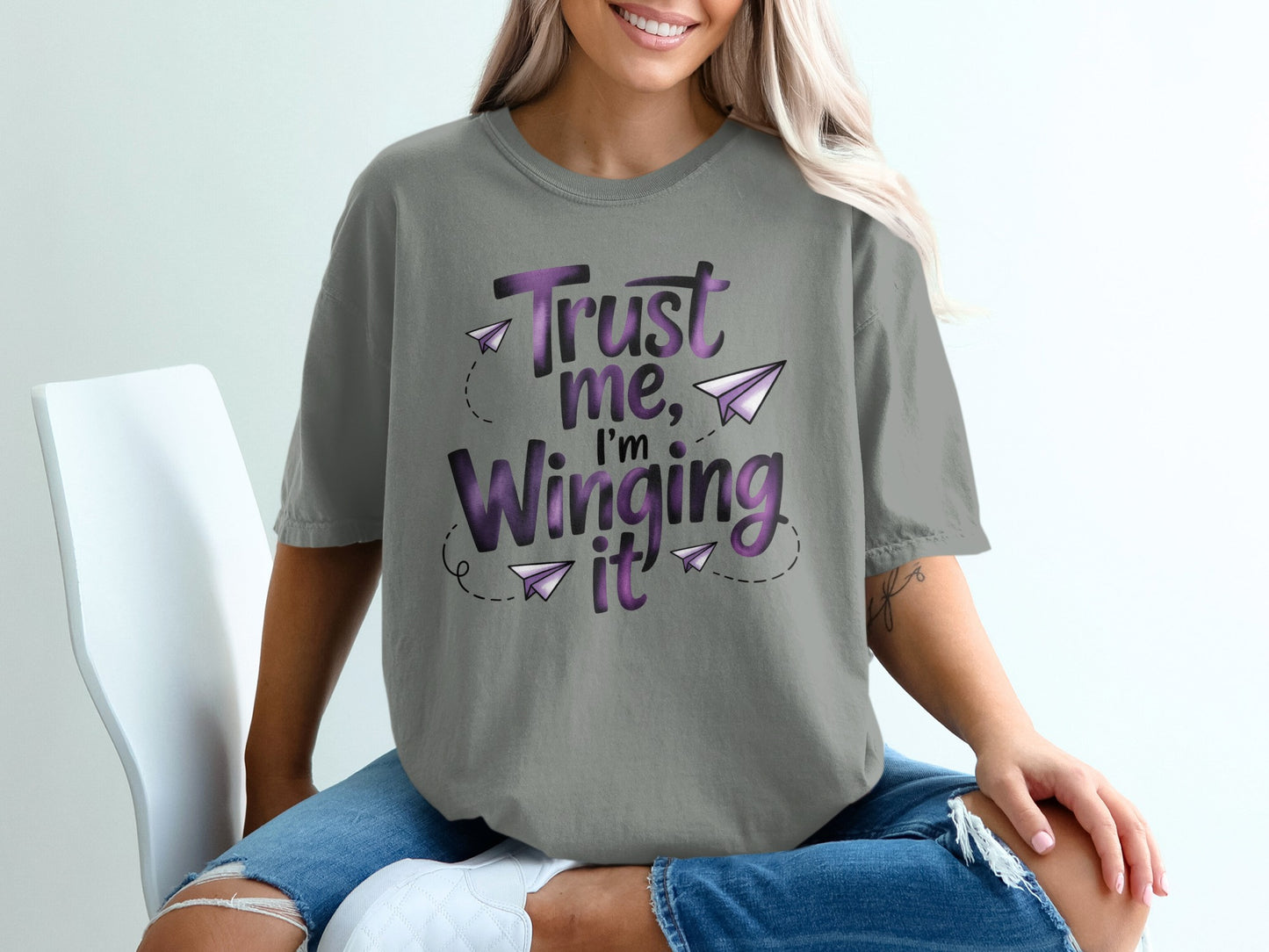 Gray t-shirt with "Trust me, I'm winging it" and paper airplanes design.
