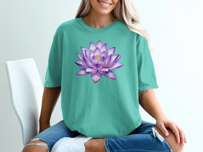 Teal t-shirt featuring a purple and pink watercolor lotus flower design.