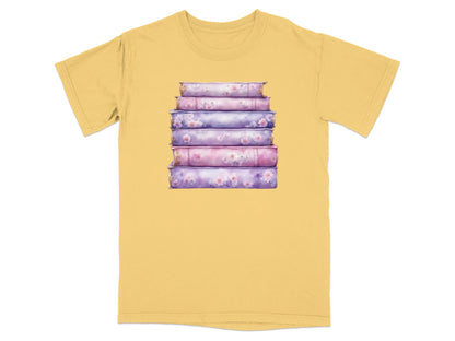 Stack of five purple and pink books with floral accents on yellow t-shirt.