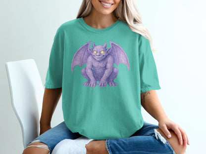 Teal t-shirt with purple gargoyle graphic.