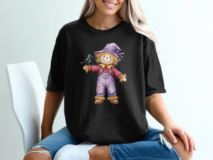 T-shirt graphic of a scarecrow with a bird on its arm.