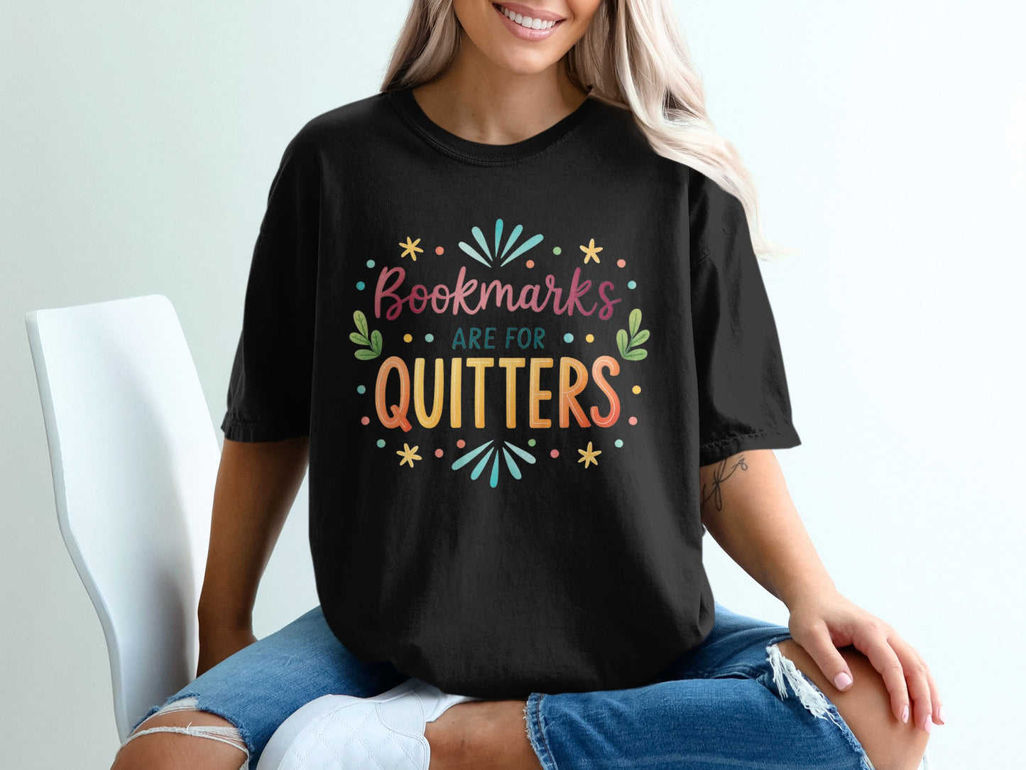 Black t-shirt with "Bookmarks are for quitters" text and colorful graphic.