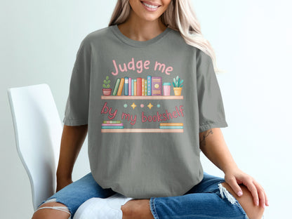 Gray t-shirt with "Judge me by my bookshelf" and books graphic.