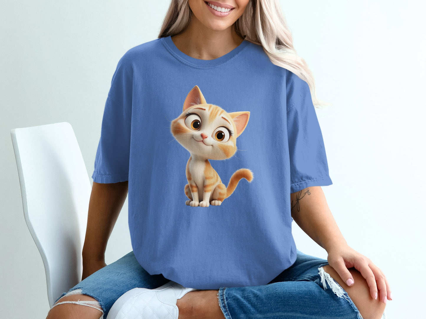 Blue t-shirt with cartoon orange kitten wearing blue t-shirt.