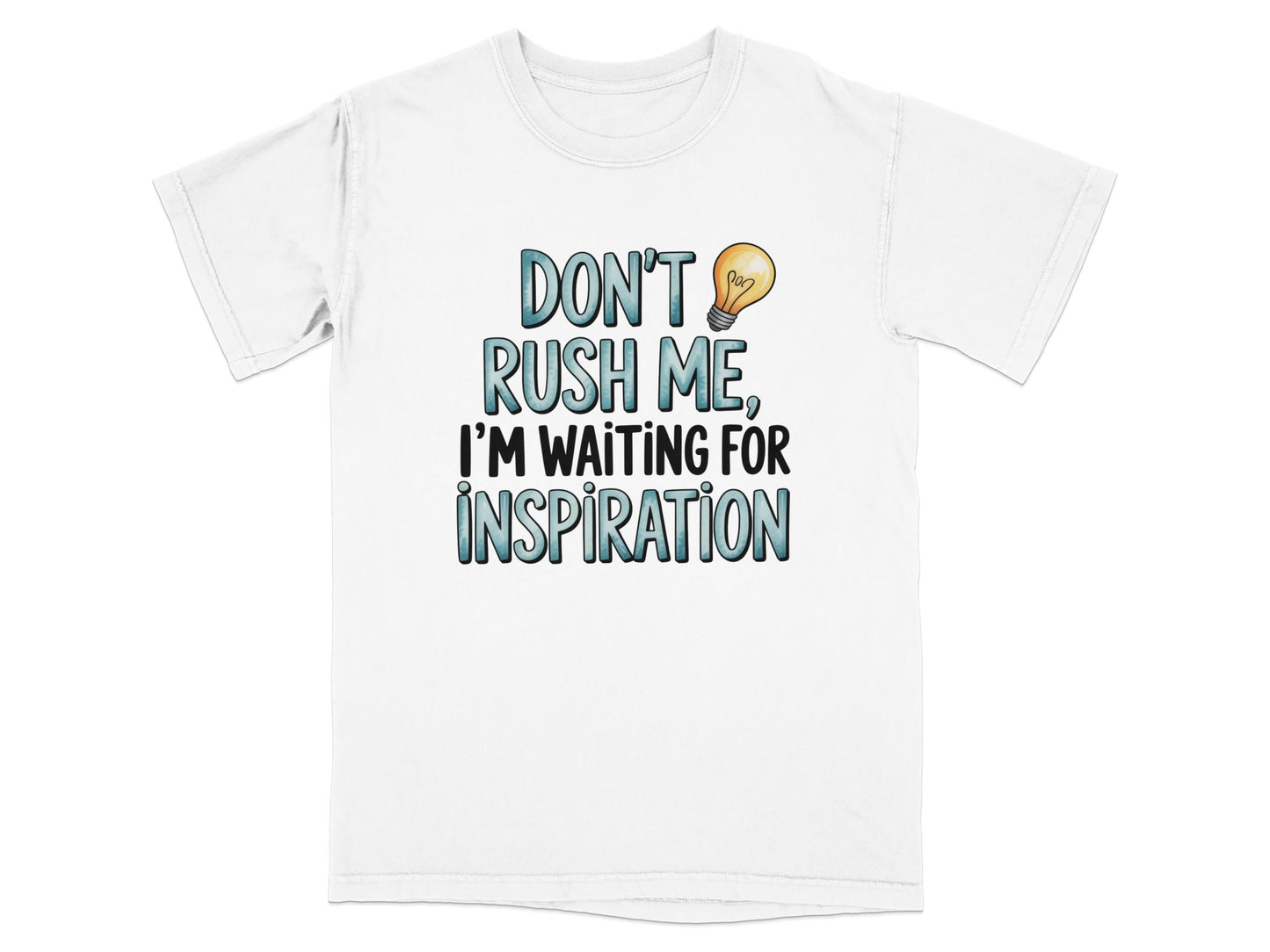 White t-shirt with "Don't Rush Me, I'm Waiting For Inspiration" text and lightbulb.