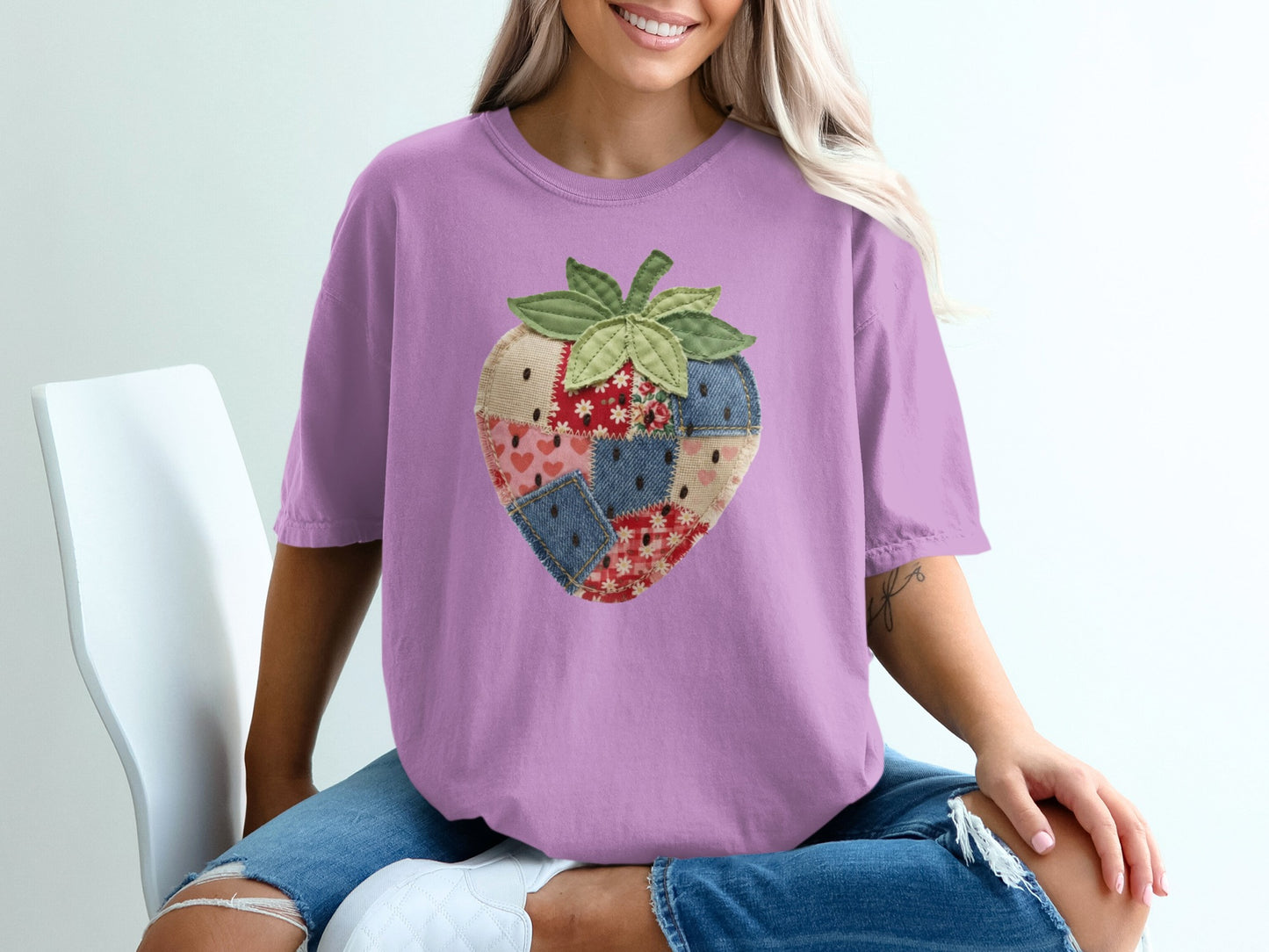 Purple t-shirt with a patchwork strawberry graphic design.