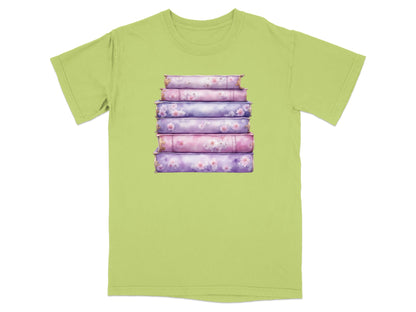 Stack of floral pattern books on a light green t-shirt.