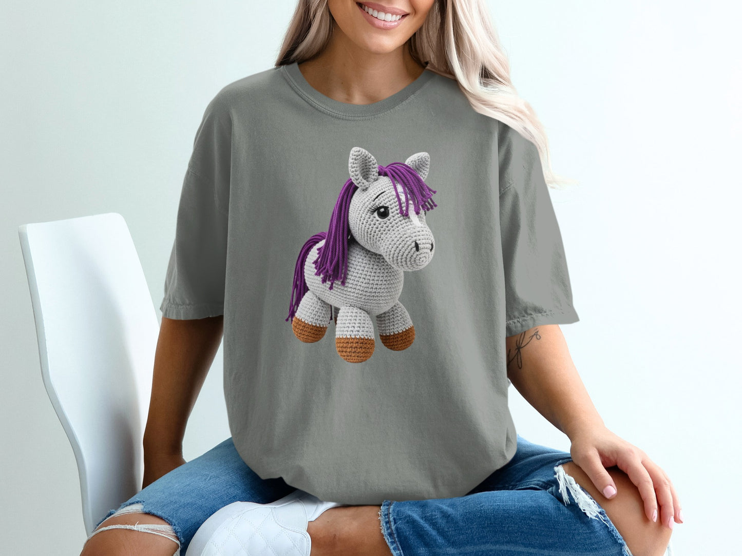 Crocheted unicorn graphic on a grey t-shirt.