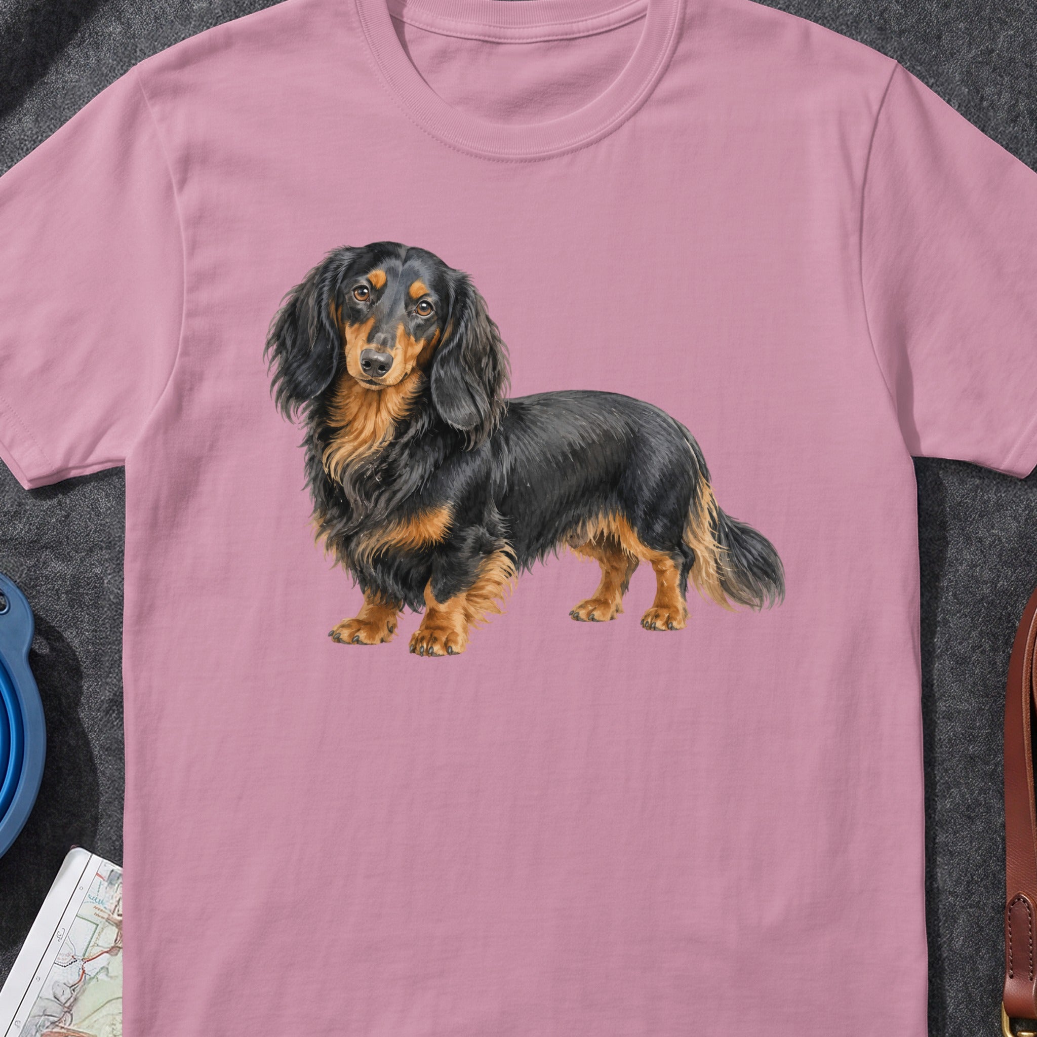 Long-haired black and tan dachshund illustration on a pink t-shirt.