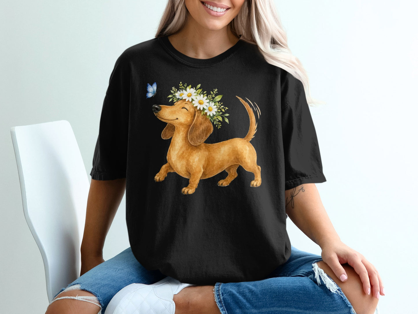 Black t-shirt with dachshund wearing a daisy crown and butterfly.