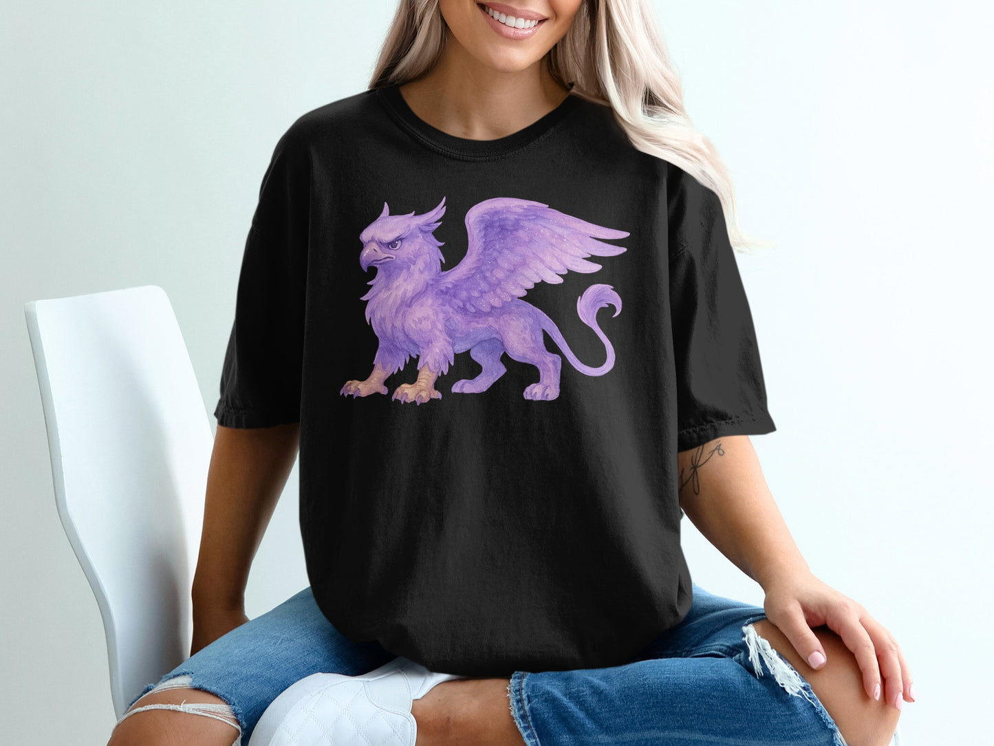 Black t-shirt with a purple gryphon illustration on the chest.